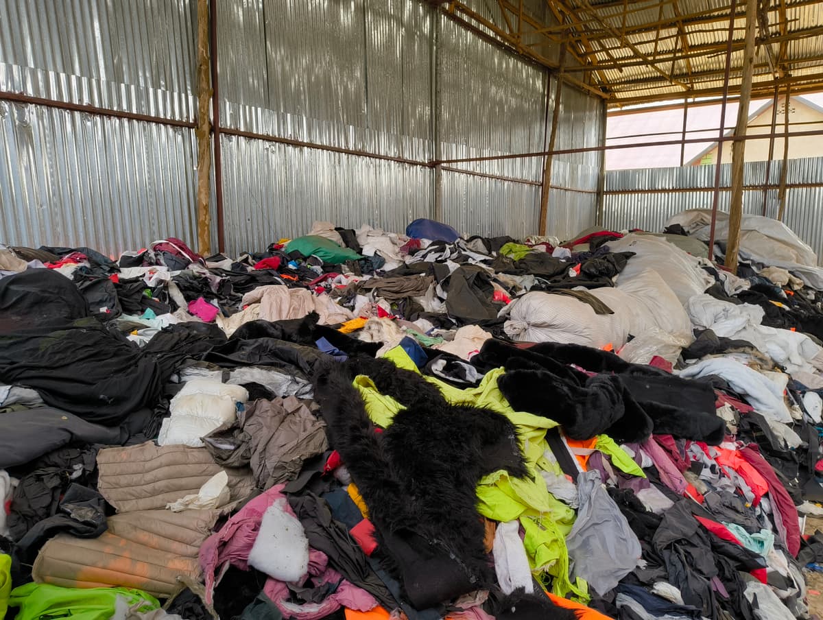 Kiraka team organizing stored fabrics